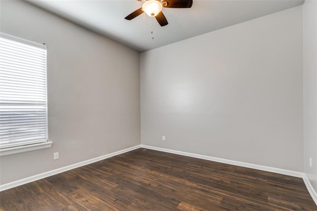 619 Buckalew Street Dallas, TX 75208 - Photo 20 of 29 a view of a room with wooden floor ceiling fan and window