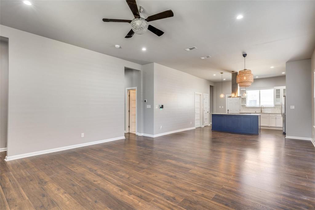619 Buckalew Street Dallas, TX 75208 - Photo 27 of 29 an empty room with wooden floor and windows