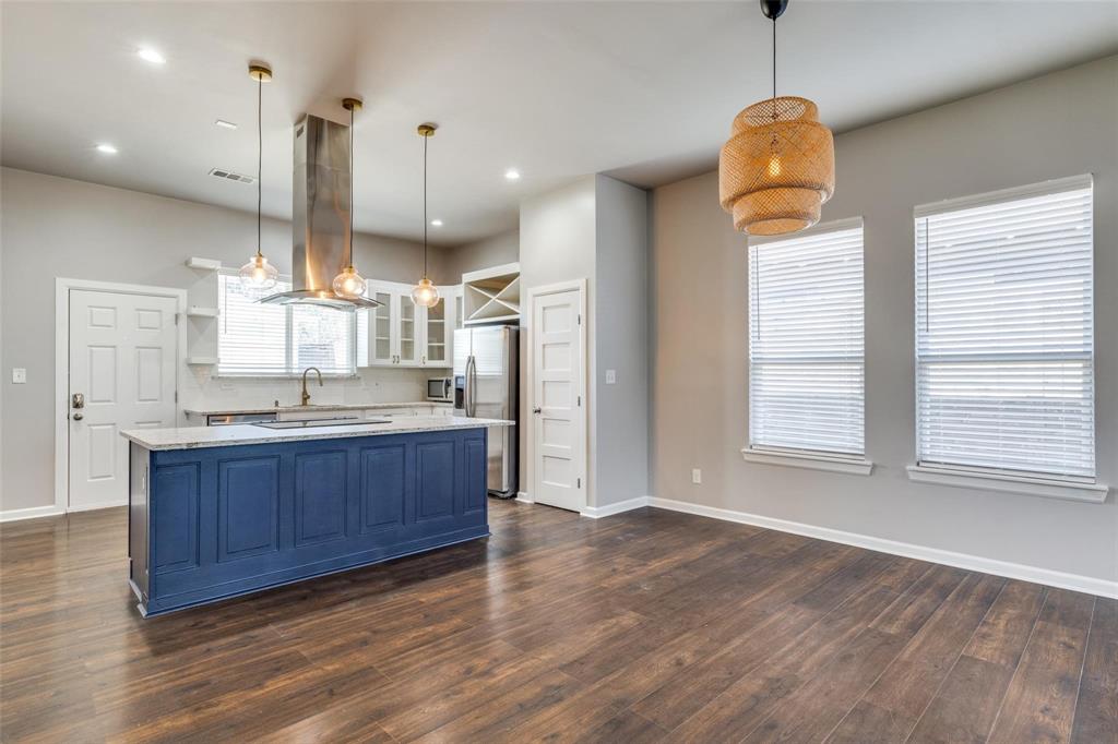 619 Buckalew Street Dallas, TX 75208 - Photo 28 of 29 a kitchen with stainless steel appliances granite countertop a sink a refrigerator and a wooden floors