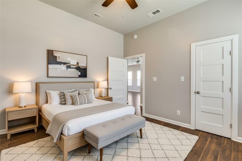 619 Buckalew Street Dallas, TX 75208 - Photo 10 of 29 a bedroom with a bed and a chandelier