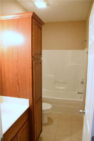 888 Locust Grove Road Watertown, TN 37184 - Photo 9 of 20 The second bath has a tile floor and nice linen cabinet.