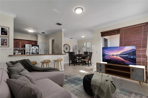 a living room with furniture a couch and chairs