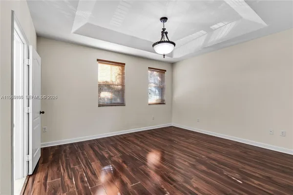 a view of a room with wooden floor and window