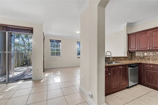a view of a kitchen with granite countertop a sink and a stove