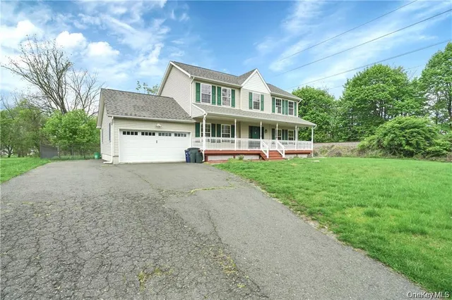 a view of a house with a yard and plants