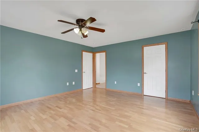 a view of an empty room window and wooden floor