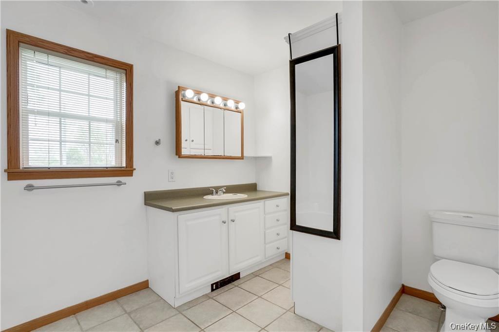 1 Tomkins Avenue Stony Point, NY 10980 - Photo 18 of 35 a bathroom with a granite countertop sink toilet and mirror