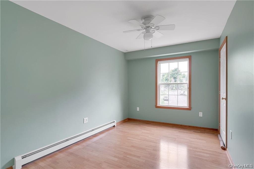 1 Tomkins Avenue Stony Point, NY 10980 - Photo 25 of 35 an empty room with a chandelier fan and windows