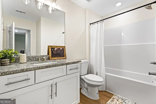 a bedroom with a bed and bathroom