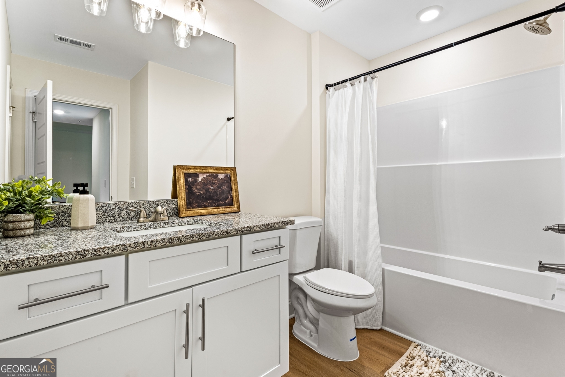 205 Starr Circle Stockbridge, GA 30281 - Photo 17 of 30 a bathroom with a granite countertop sink a toilet and shower
