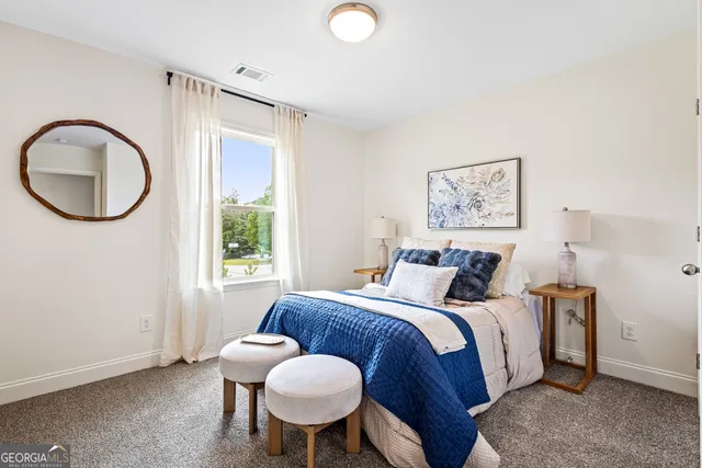 a bed with white sheets and pillows on it