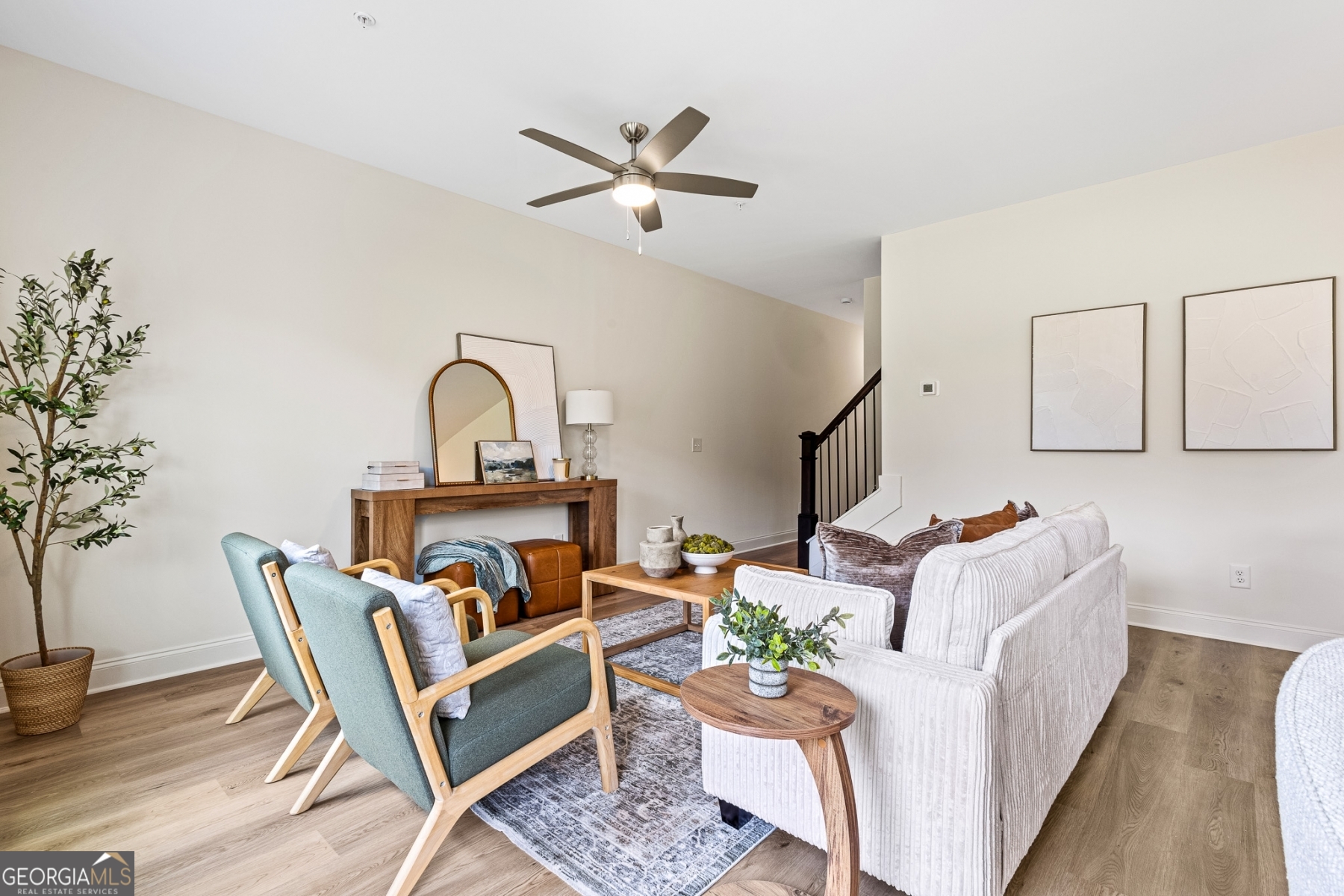 205 Starr Circle Stockbridge, GA 30281 - Photo 5 of 30 a living room with furniture a rug and a potted plant