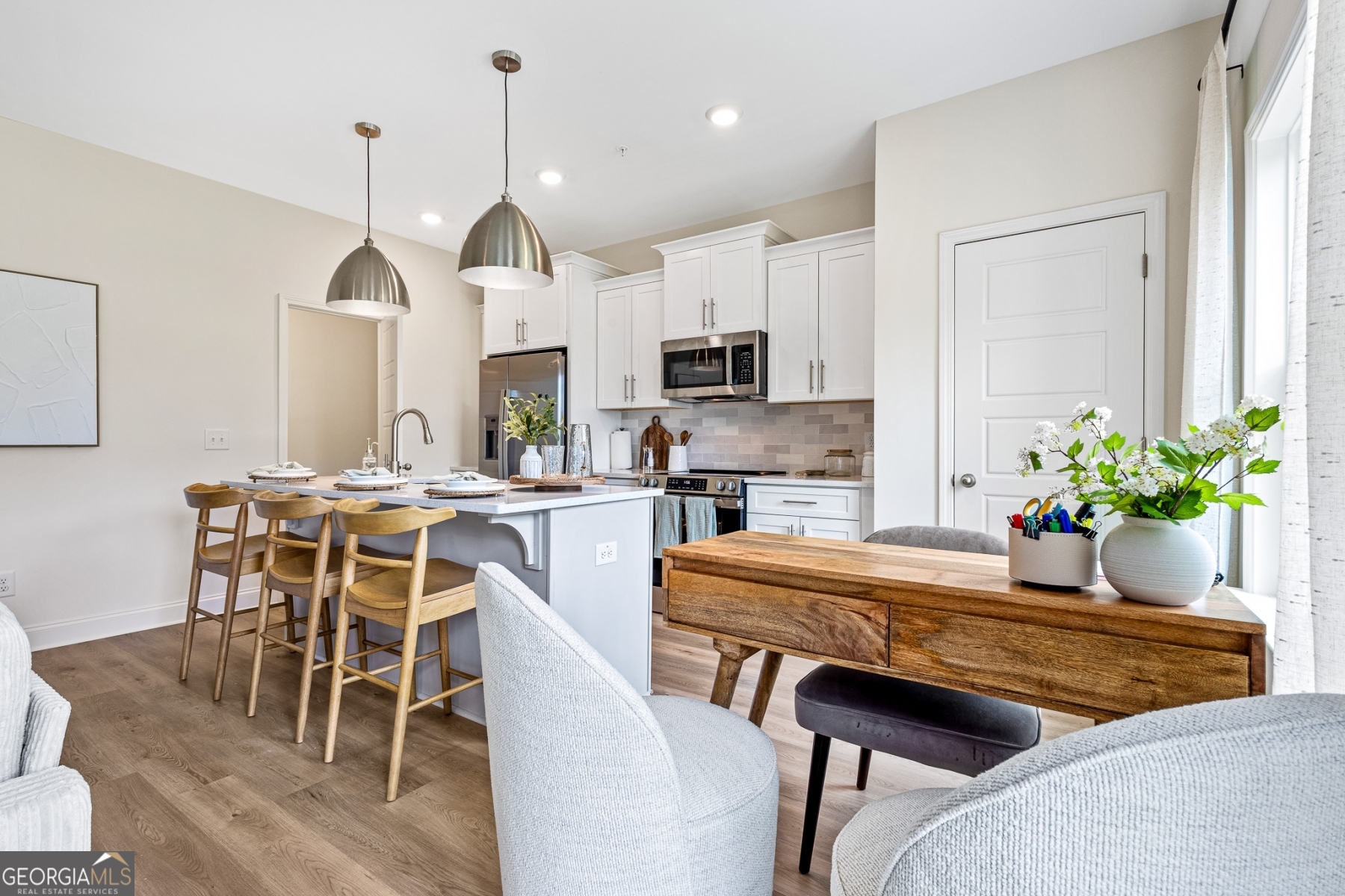 205 Starr Circle Stockbridge, GA 30281 - Photo 9 of 30 a dining room with furniture a chandelier and kitchen view