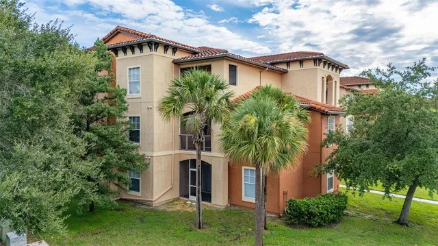 a front view of a house with a yard and trees