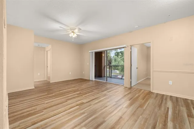 a view of a kitchen with wooden floor and a ceiling fan