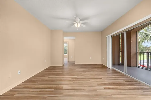 a view of a kitchen with wooden floor and a window