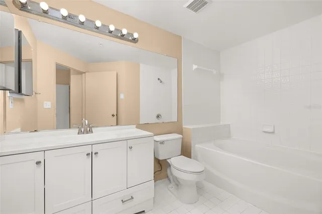 an empty room with a window and ceiling fan