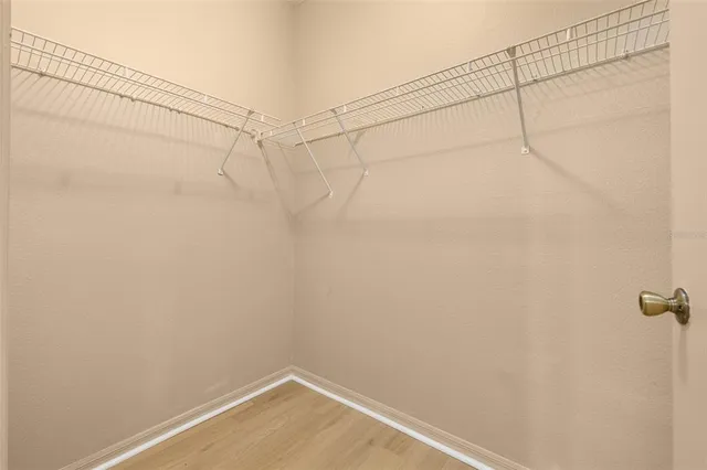 a bathroom with a double vanity sink a toilet a mirror and shower