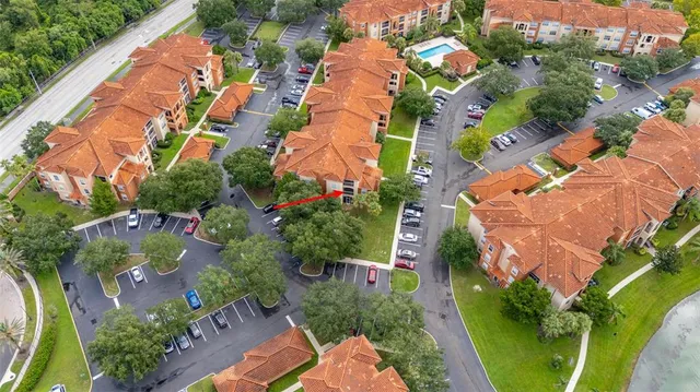 a front view of a house with a garden and tree