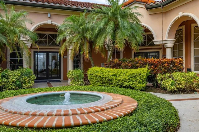 an aerial view of residential houses with outdoor space and parking