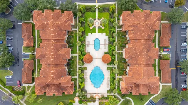 an aerial view of a house with outdoor space pool seating area and yard