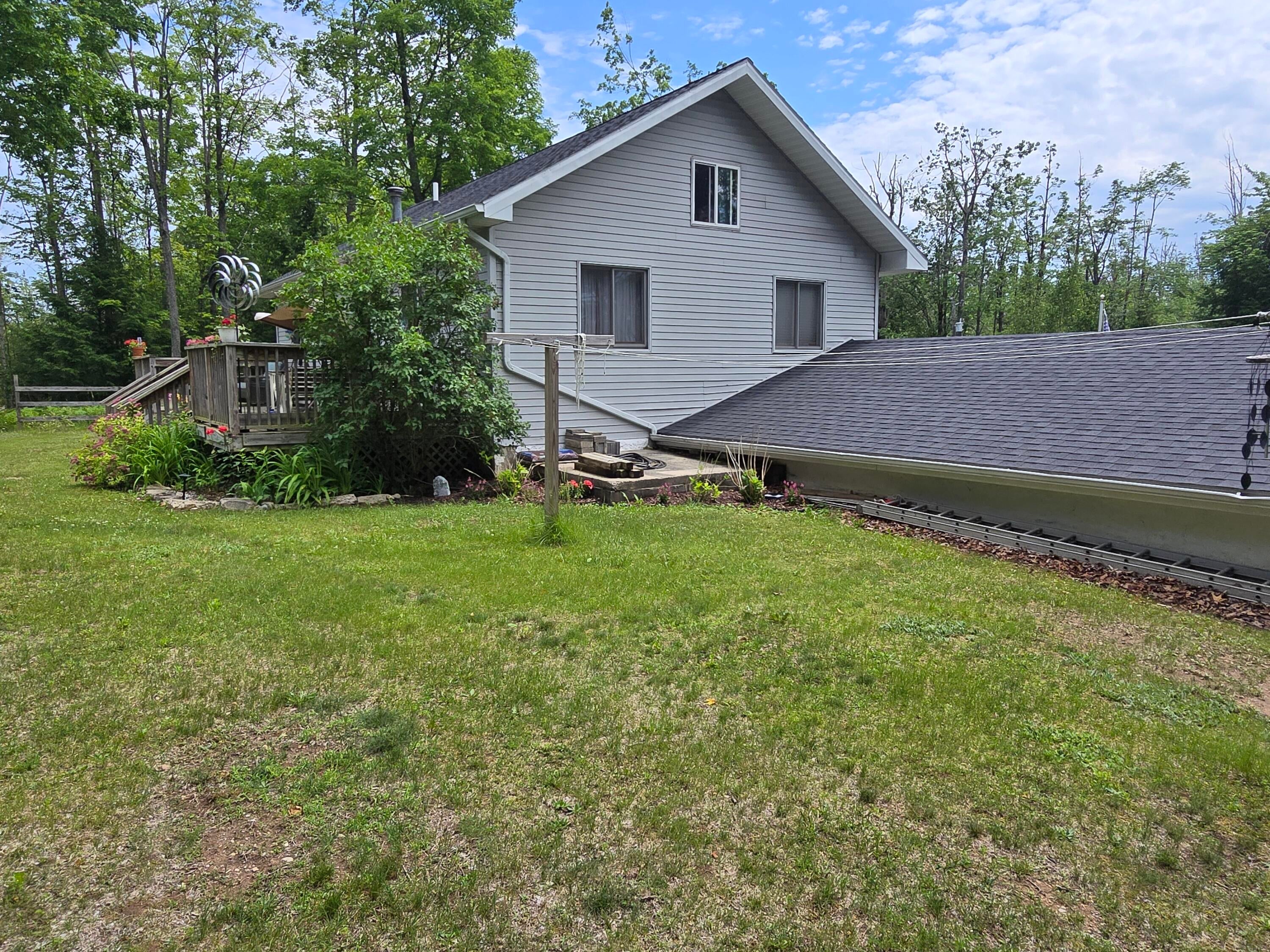 5500 Oley Lake Road Gaylord, MI 49735 - Photo 30 of 44 Backyard in the summer 2025