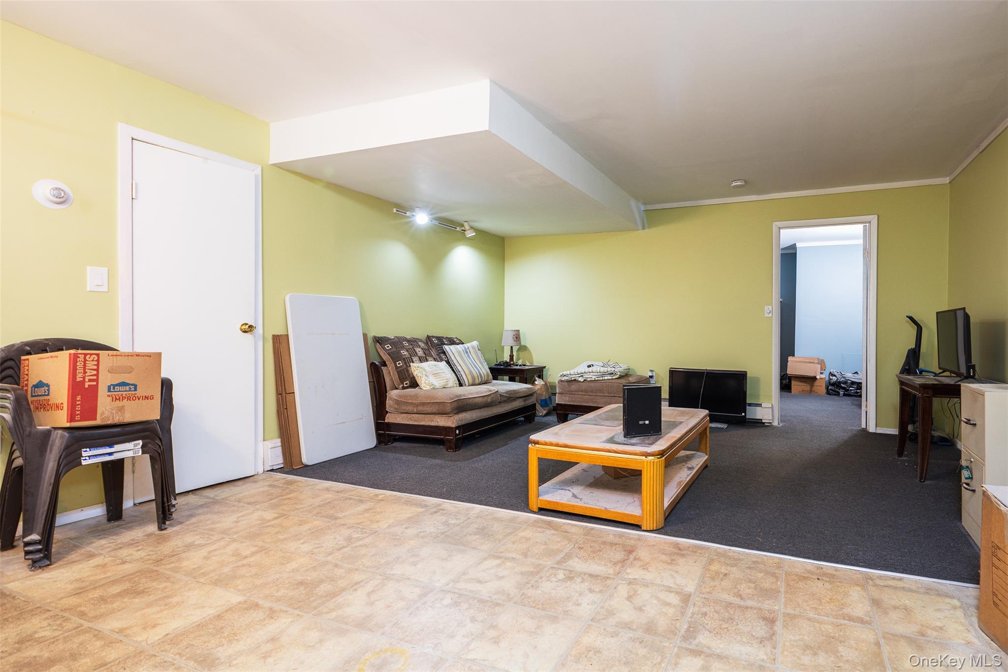 2 Fenwick Street Mastic, NY 11950 - Photo 16 of 27 a living room with furniture and a flat screen tv
