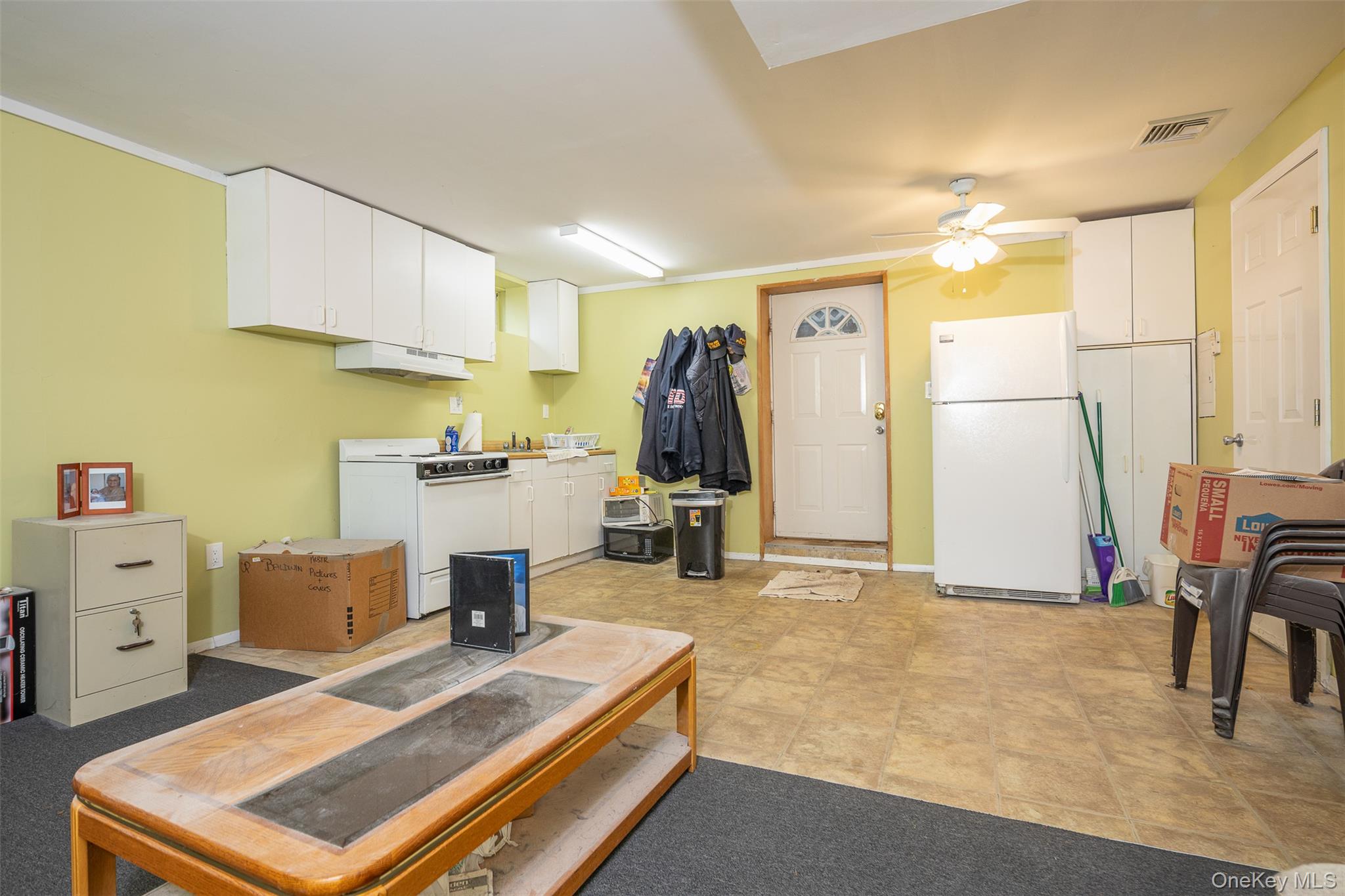 2 Fenwick Street Mastic, NY 11950 - Photo 17 of 27 a living room with furniture and a flat screen tv
