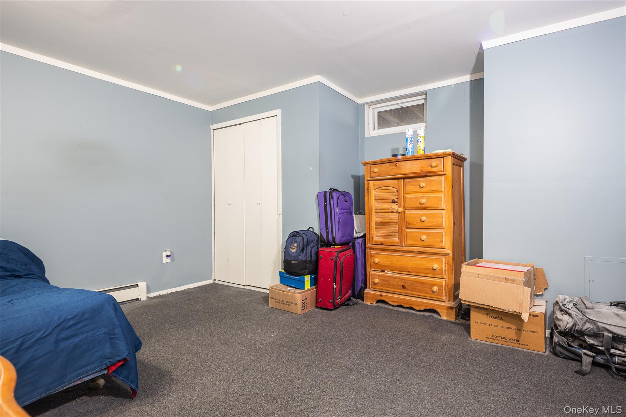 2 Fenwick Street Mastic, NY 11950 - Photo 18 of 27 a bedroom with a bed and a window