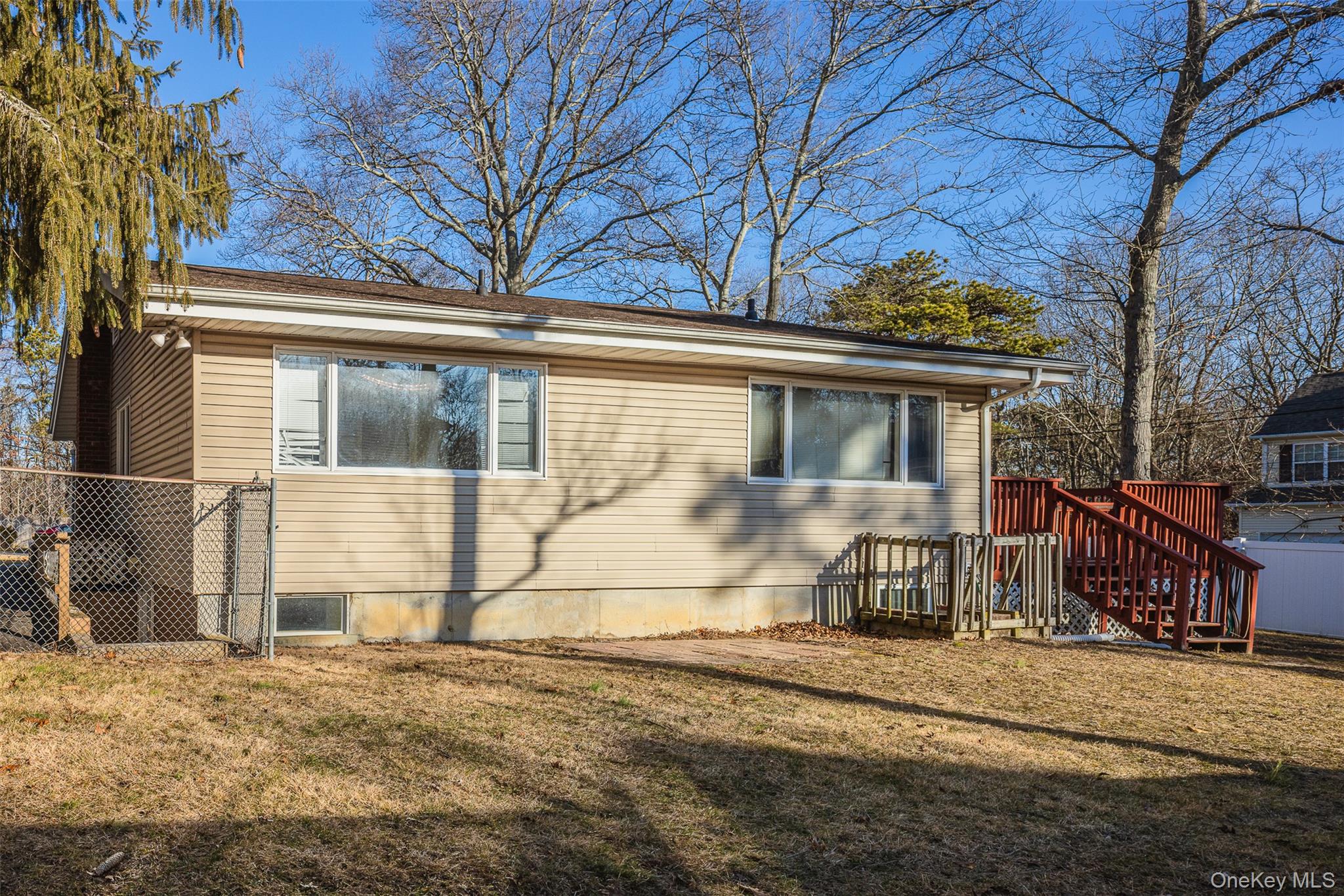 2 Fenwick Street Mastic, NY 11950 - Photo 19 of 27 a view of a house with a yard covered in snow