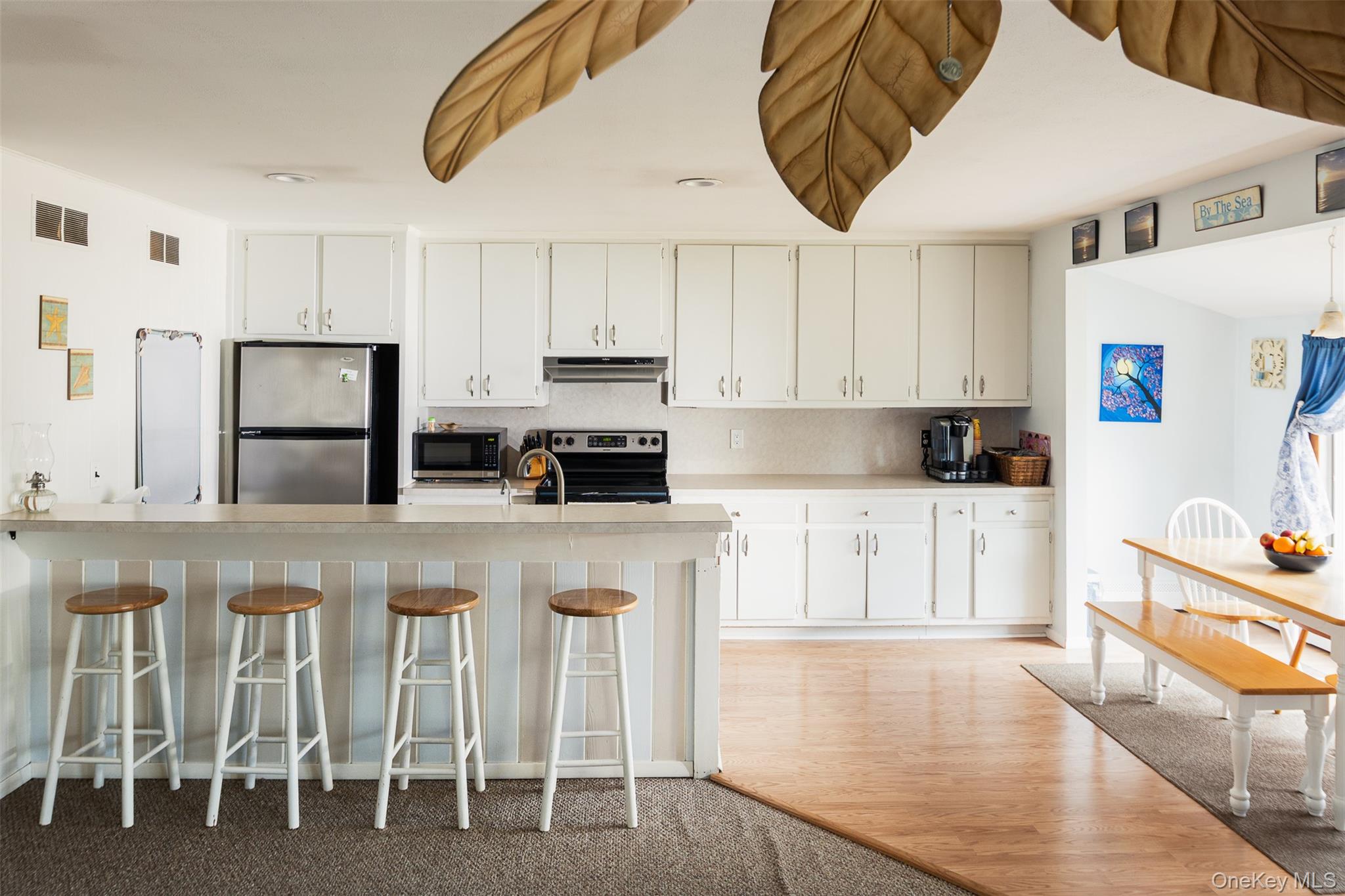 2 Fenwick Street Mastic, NY 11950 - Photo 4 of 27 a kitchen with table chairs cabinets and stainless steel appliances