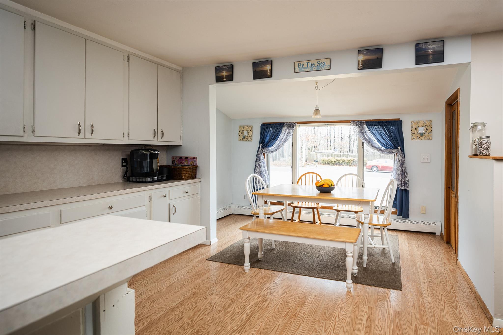 2 Fenwick Street Mastic, NY 11950 - Photo 5 of 27 a kitchen with a refrigerator and a stove top oven