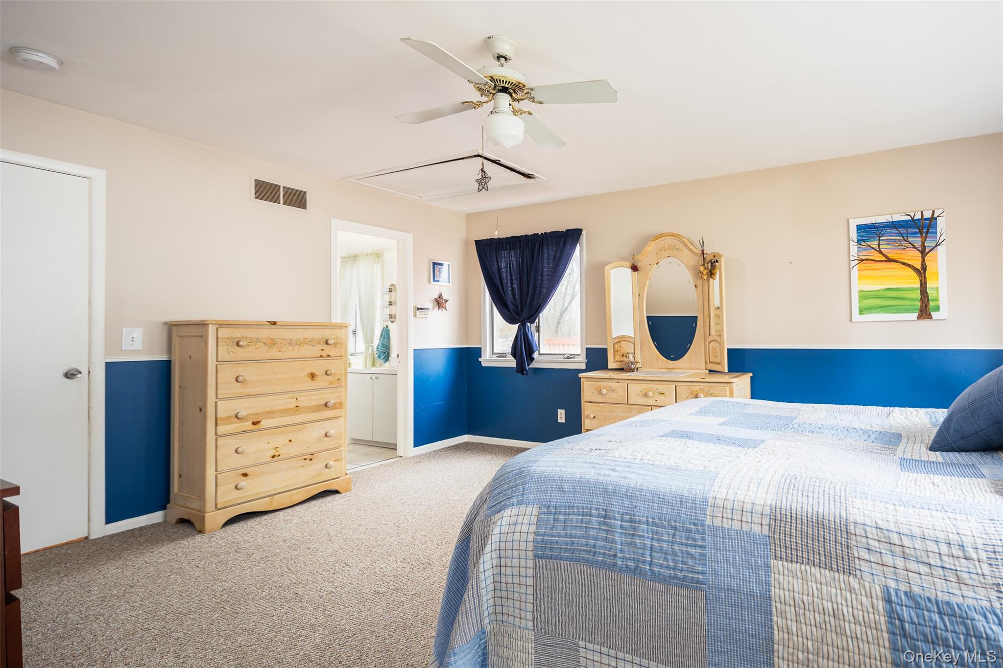 2 Fenwick Street Mastic, NY 11950 - Photo 8 of 27 a bedroom with a large bed and a chandelier