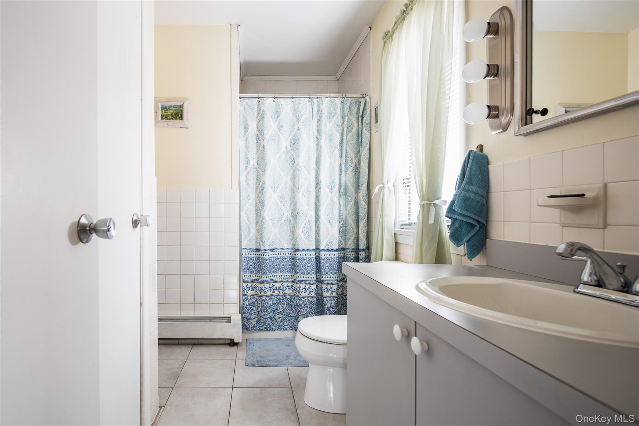2 Fenwick Street Mastic, NY 11950 - Photo 9 of 27 a bathroom with a sink a toilet and shower