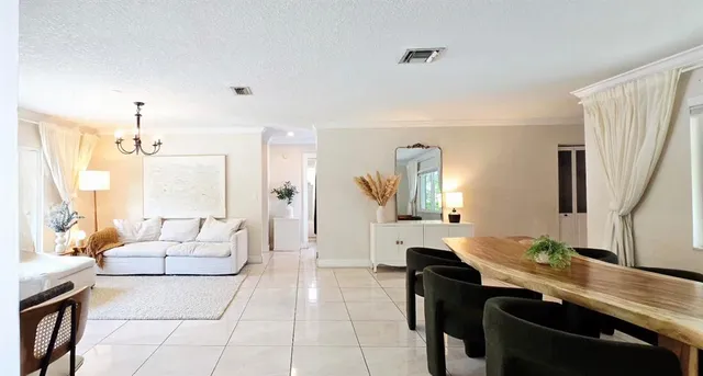 a large living room with hard wood flooring