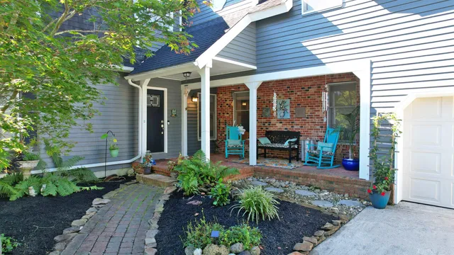 a front view of a house with a yard garage and trees