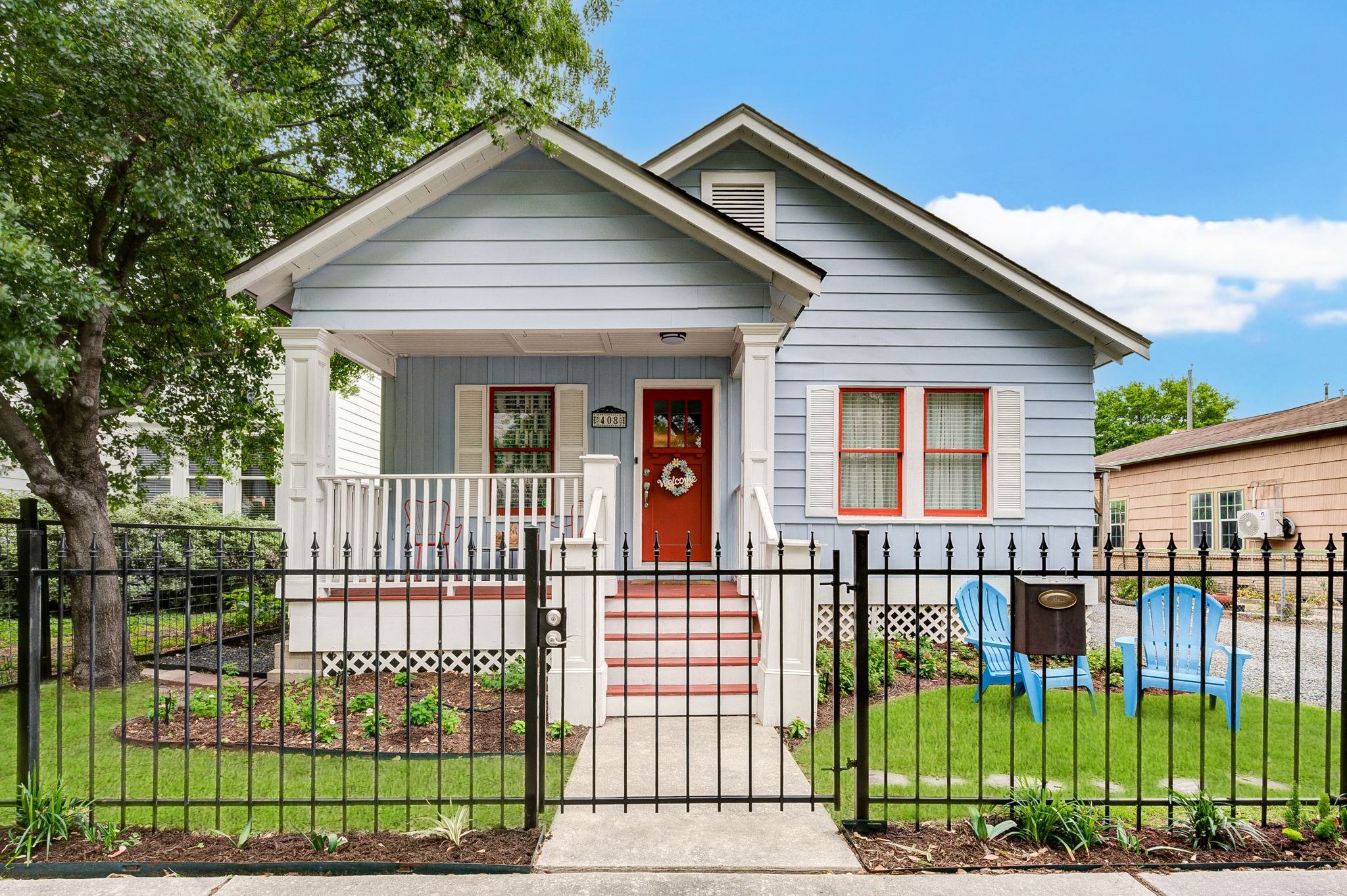 a view of a house with a small yard and plants