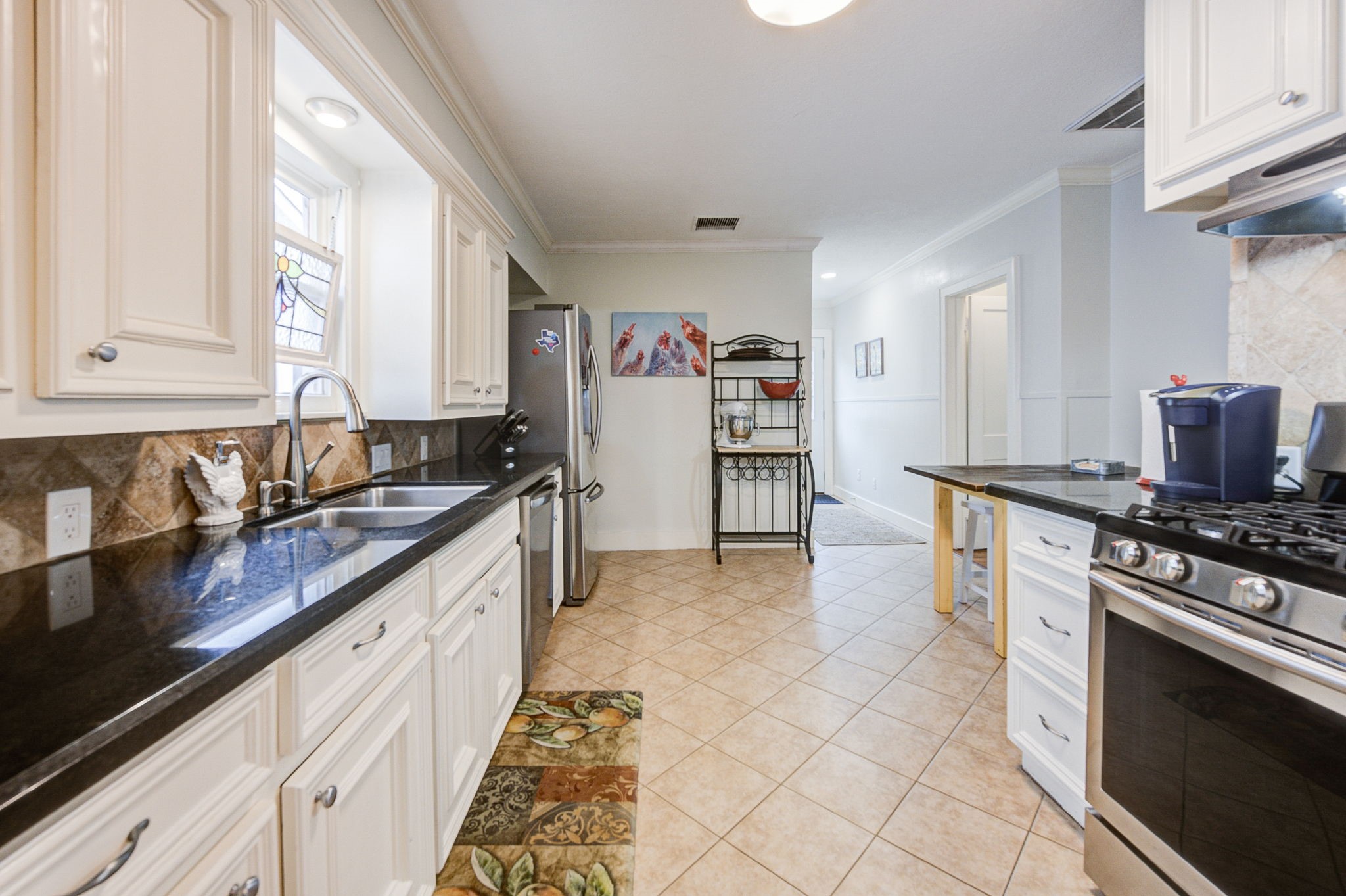 408 Tabor Street Houston, TX 77009 - Photo 15 of 35 a kitchen with stainless steel appliances granite countertop a stove a sink and a microwave