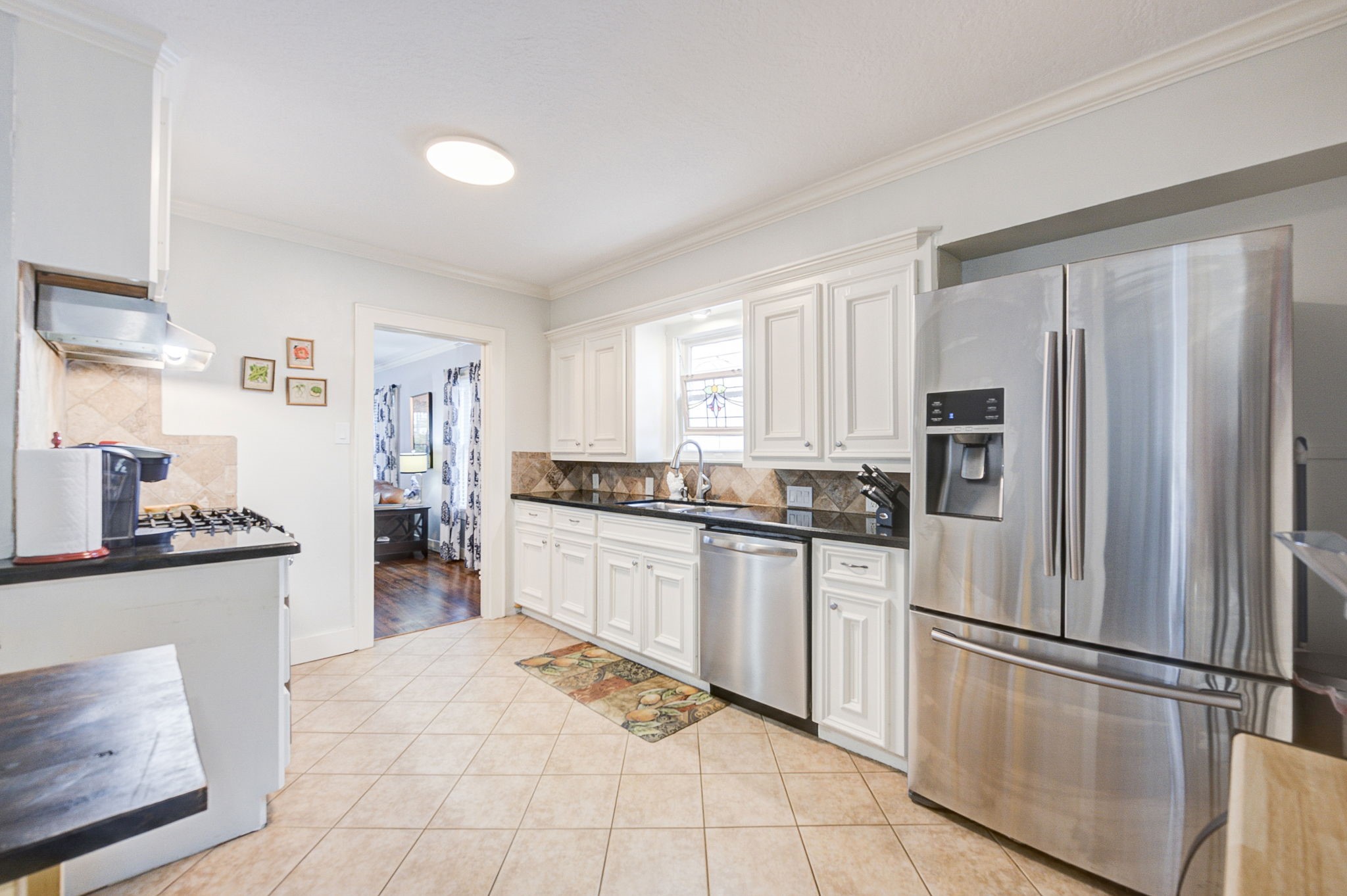408 Tabor Street Houston, TX 77009 - Photo 16 of 35 a kitchen with stainless steel appliances a refrigerator sink and cabinets
