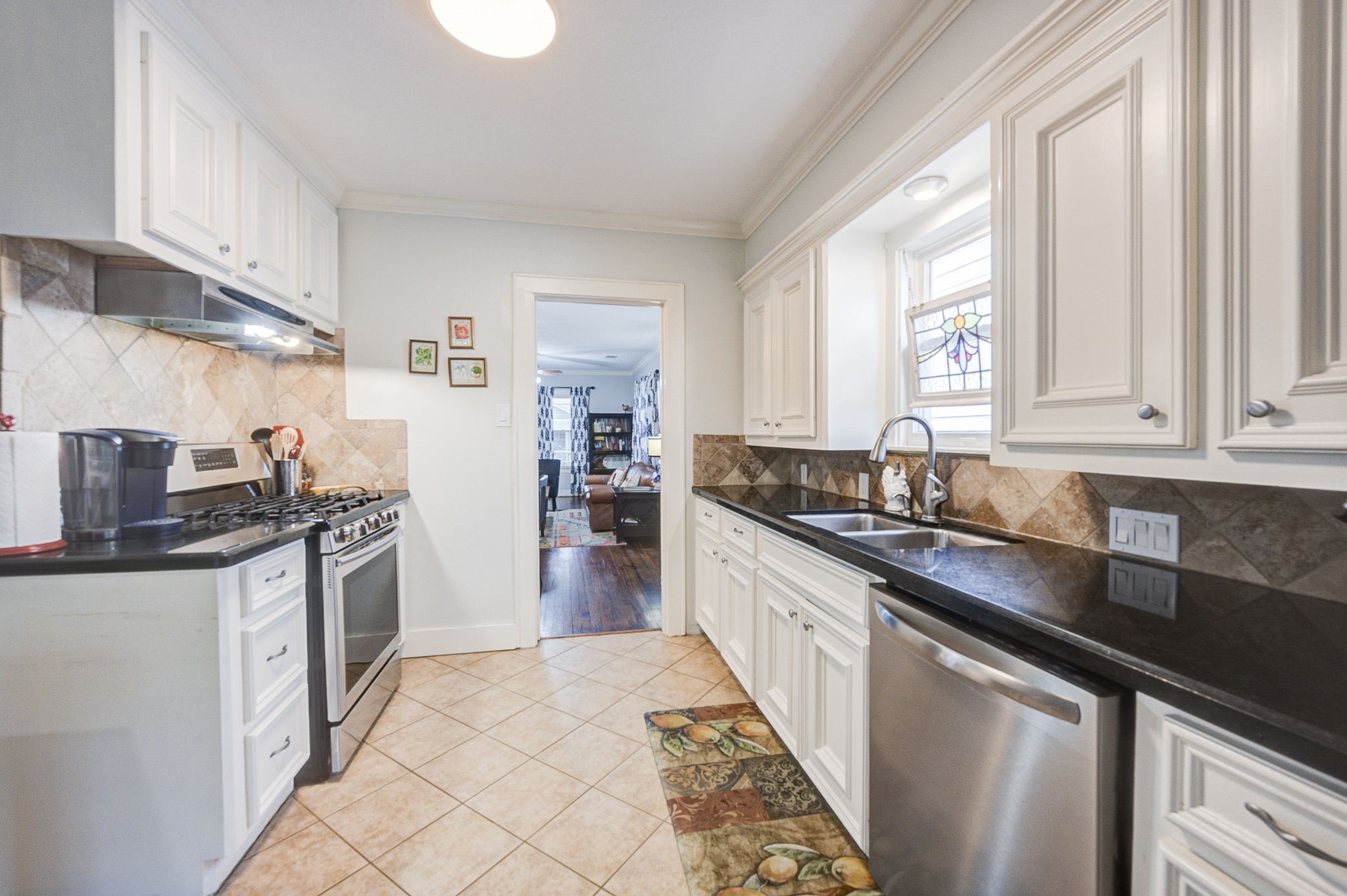 408 Tabor Street Houston, TX 77009 - Photo 17 of 35 a kitchen with stainless steel appliances granite countertop a sink and a stove