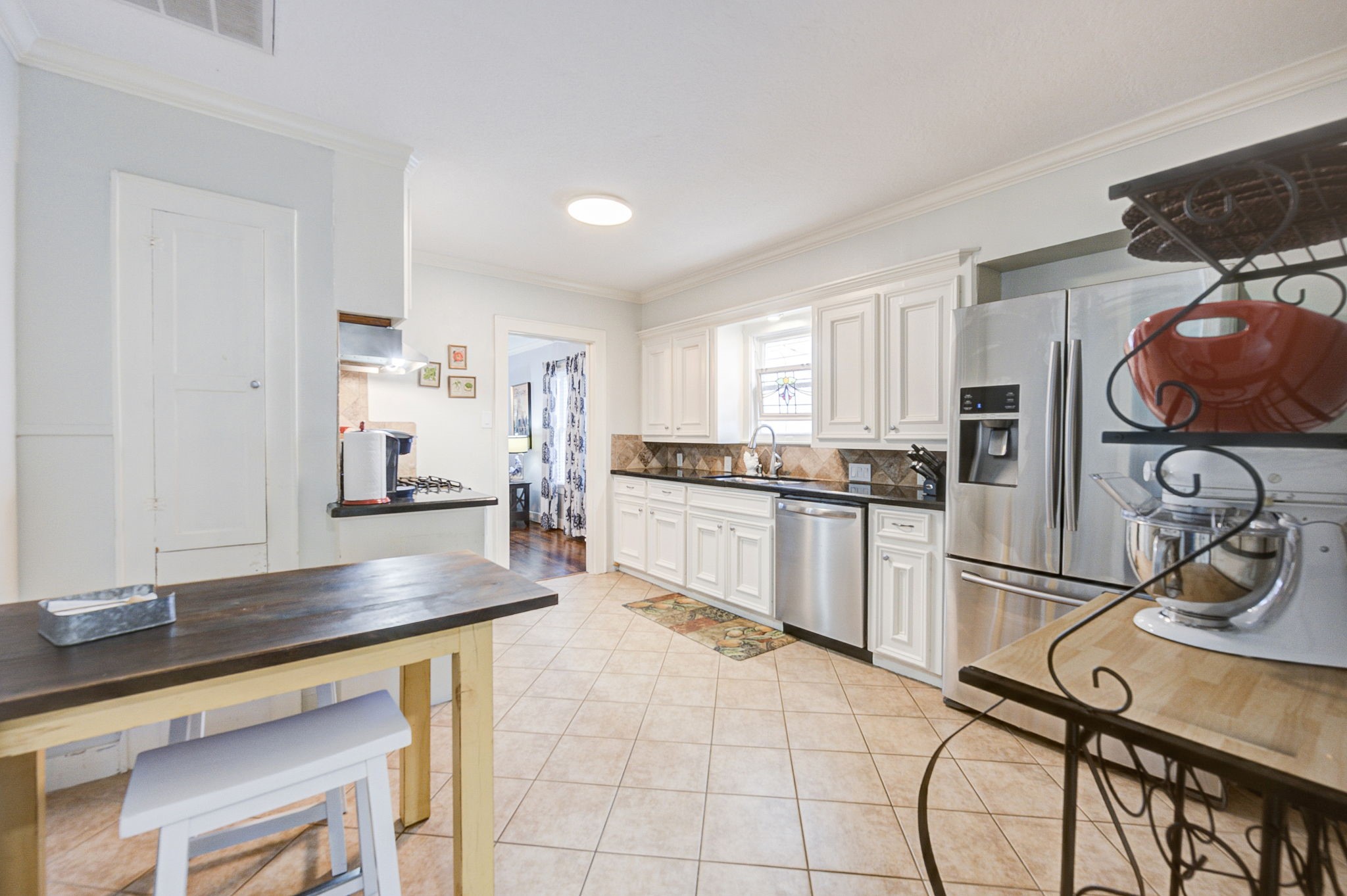 408 Tabor Street Houston, TX 77009 - Photo 18 of 35 a kitchen with granite countertop a refrigerator and cabinets