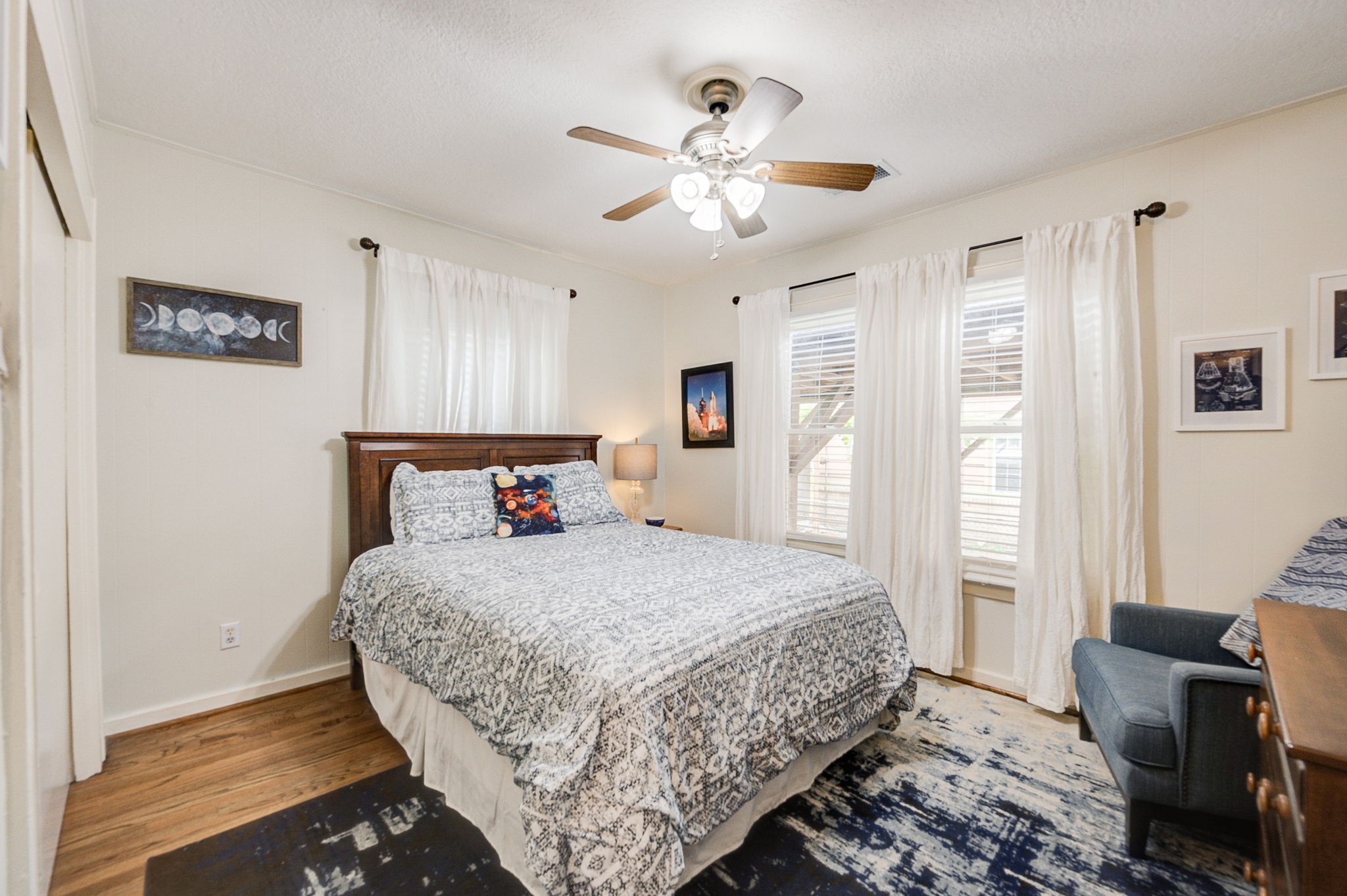 408 Tabor Street Houston, TX 77009 - Photo 21 of 35 a bedroom with a large bed and a chandelier