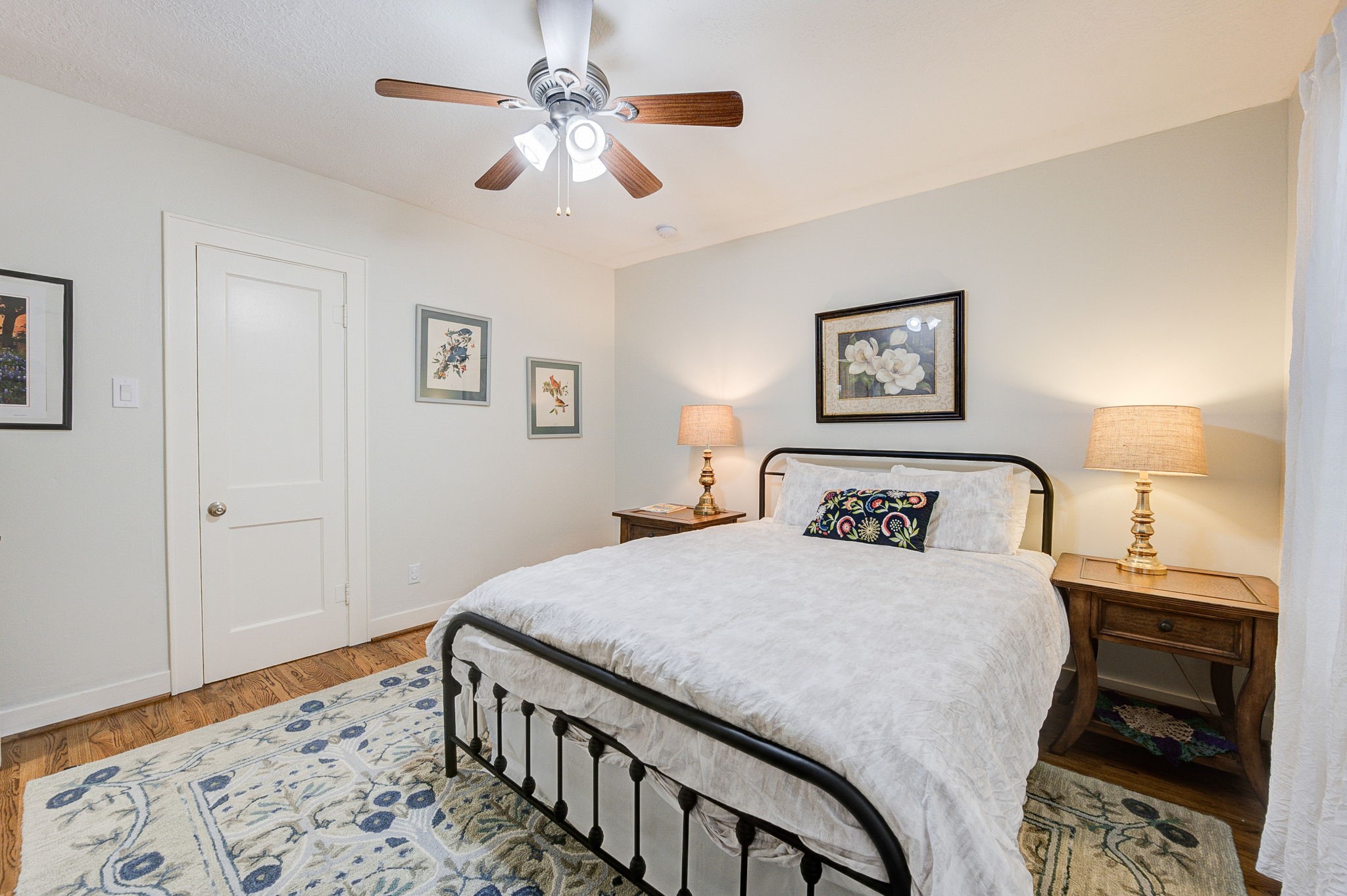 408 Tabor Street Houston, TX 77009 - Photo 25 of 35 a bedroom with a large bed and a chandelier
