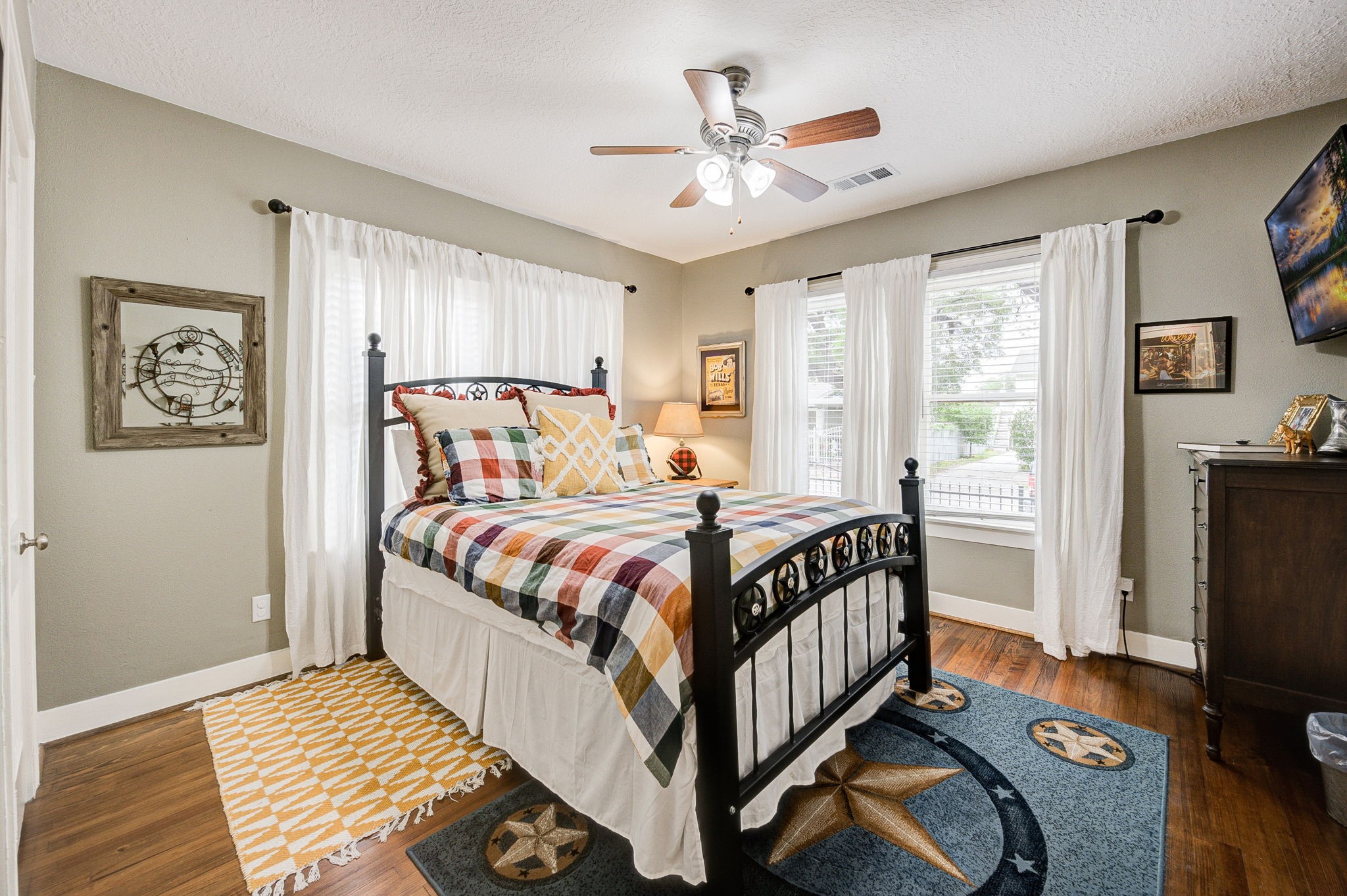 408 Tabor Street Houston, TX 77009 - Photo 26 of 35 a bedroom with a bed and a chandelier