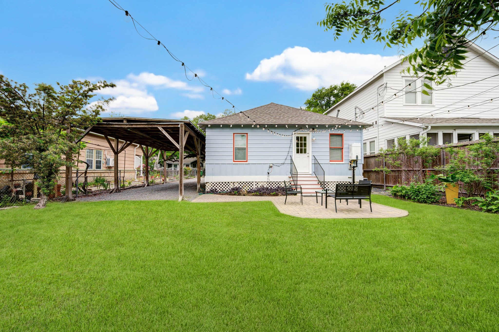 408 Tabor Street Houston, TX 77009 - Photo 33 of 35 a view of a house with patio and a garden