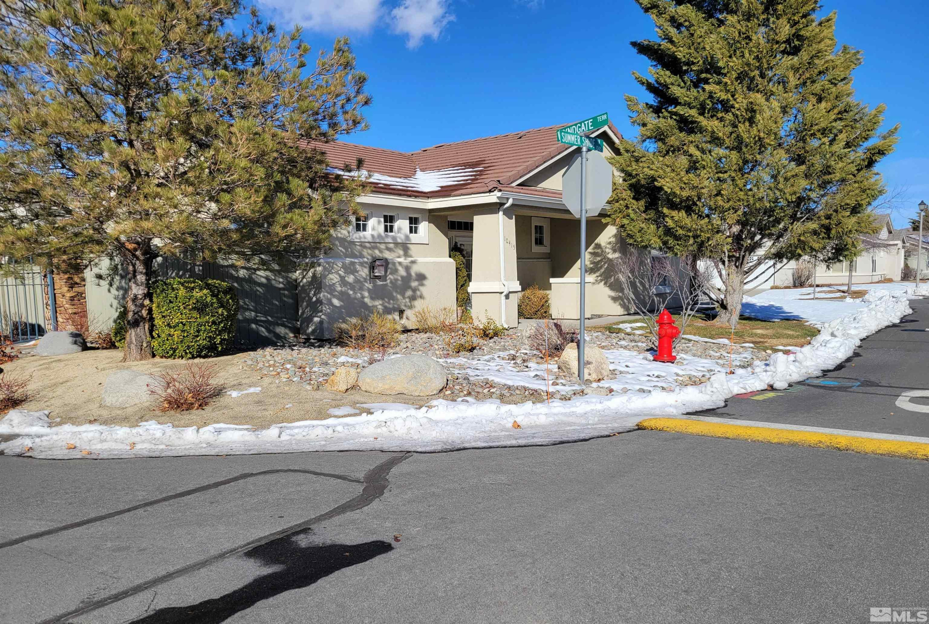 10415 Summershade Lane Reno, NV 89521 - Photo 1 of 15 a view of a house with snow on the road