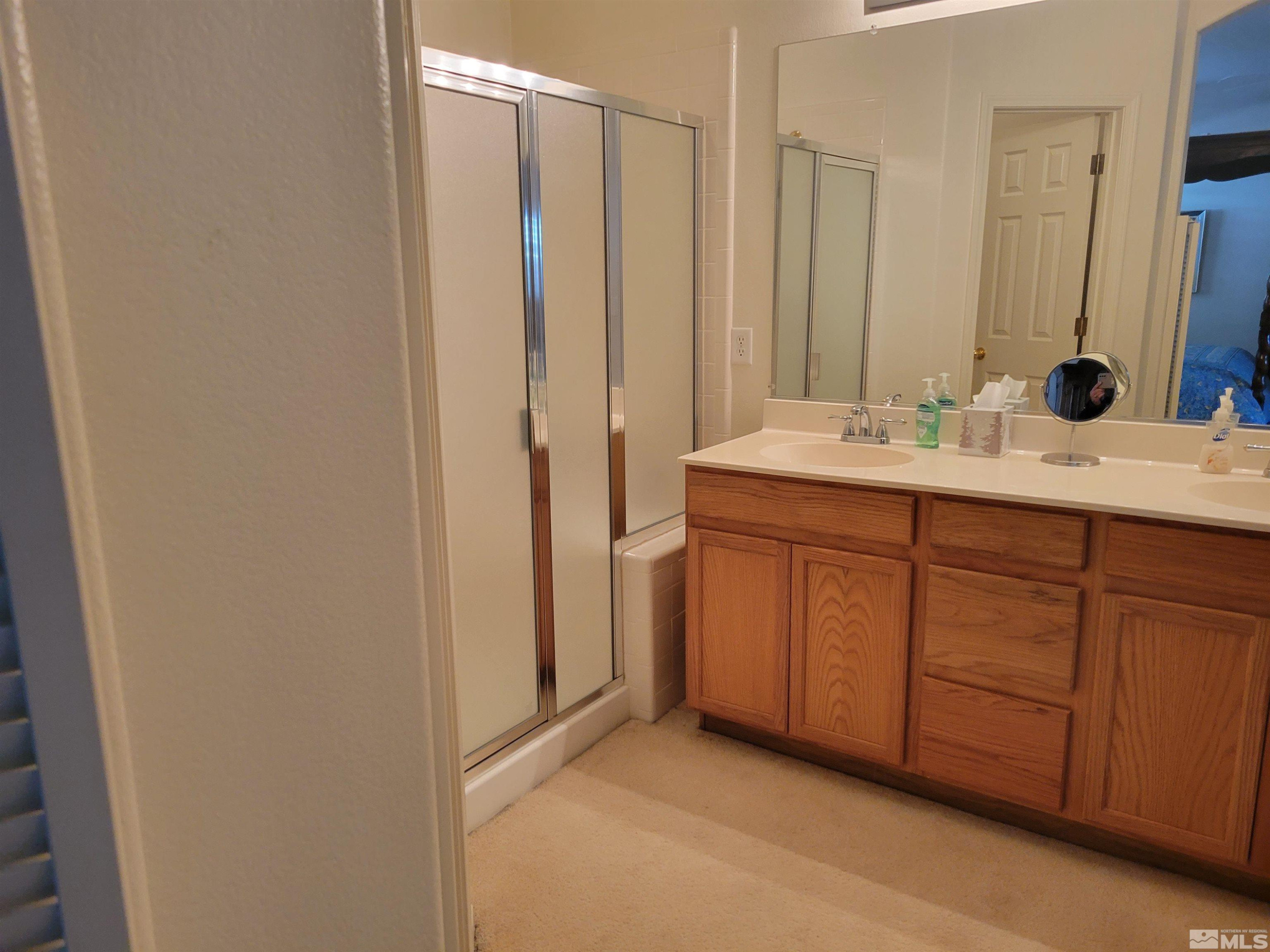 10415 Summershade Lane Reno, NV 89521 - Photo 12 of 15 a bathroom with a double vanity sink and a mirror