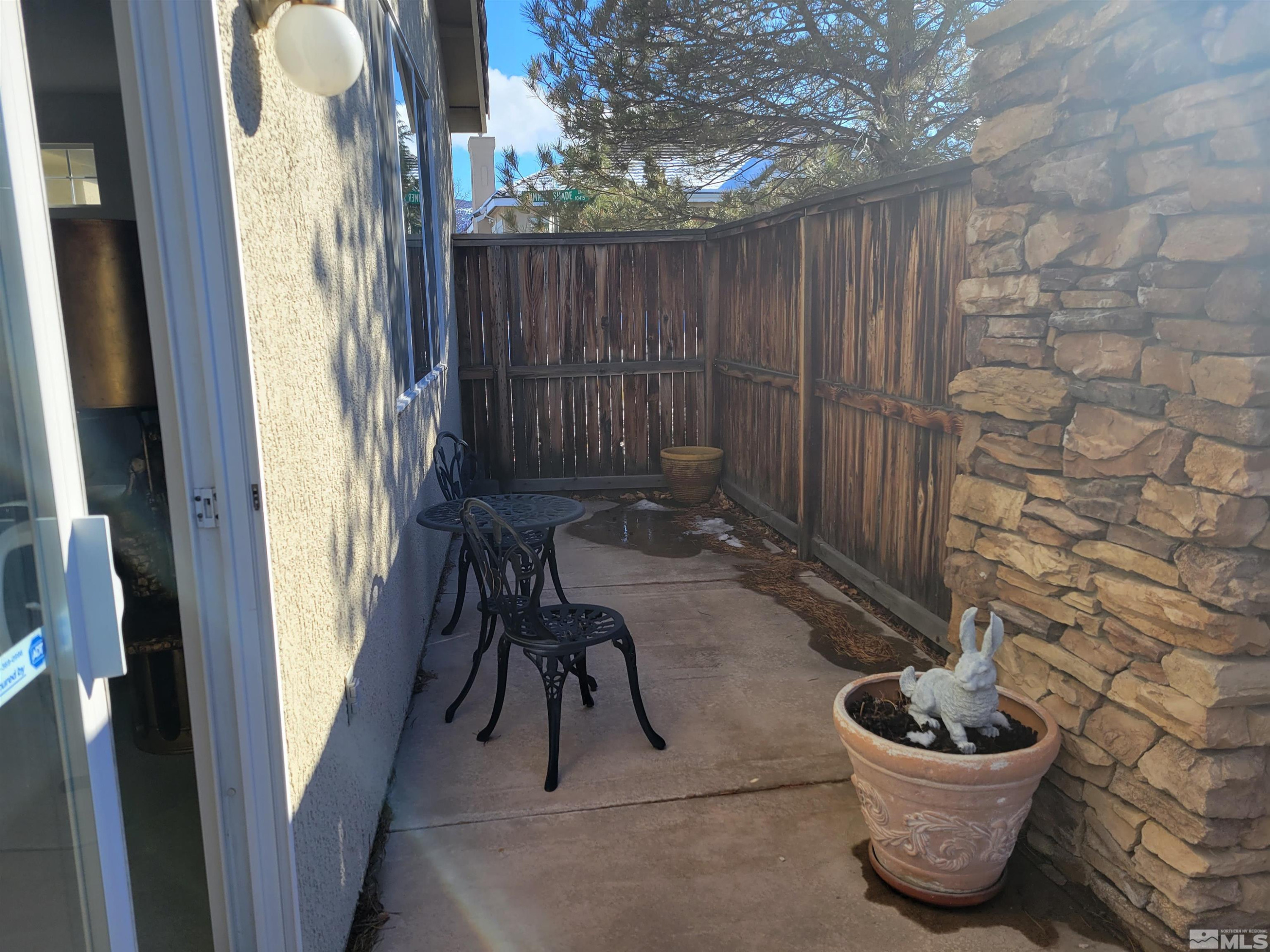 10415 Summershade Lane Reno, NV 89521 - Photo 3 of 15 a view of a porch with chairs and a potted plant