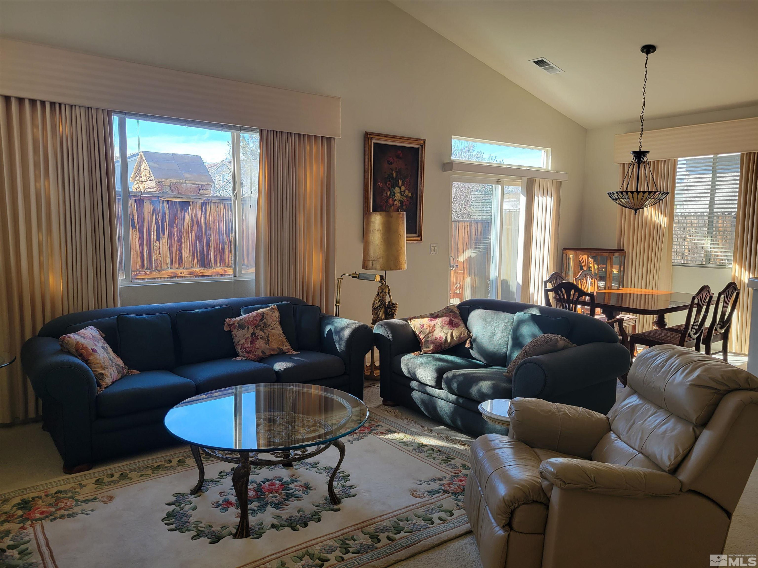 10415 Summershade Lane Reno, NV 89521 - Photo 5 of 15 a living room with furniture and a large window