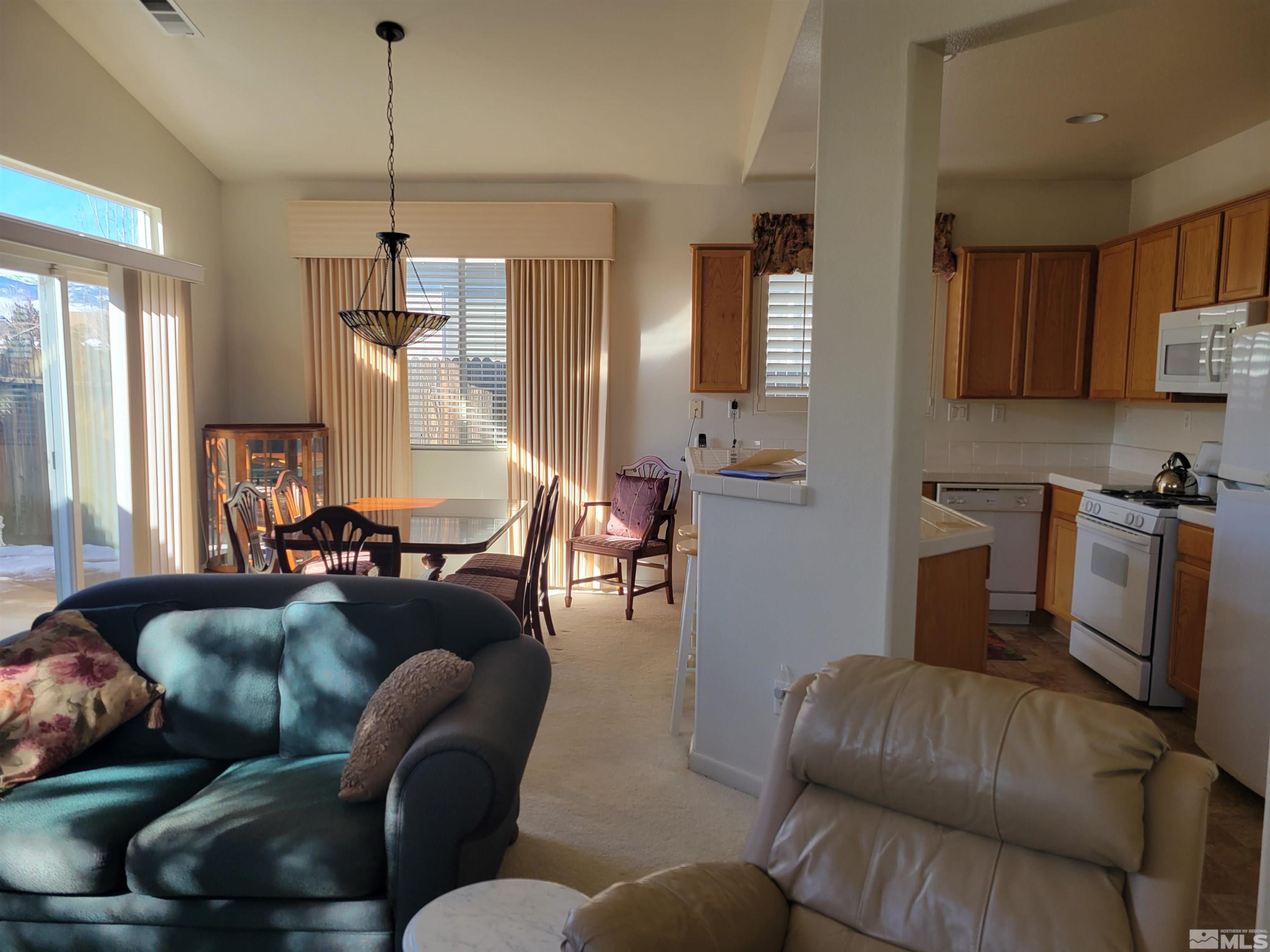 10415 Summershade Lane Reno, NV 89521 - Photo 6 of 15 a living room with furniture and a chandelier
